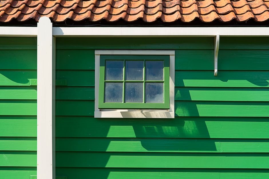 House facade with a freshly painted wall and door