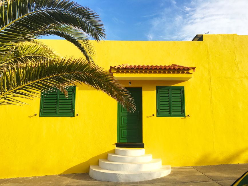 Side of a home with painted walls under daylight