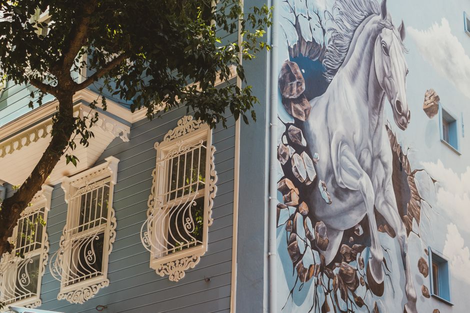Painted exterior wall of a house with a window and trim